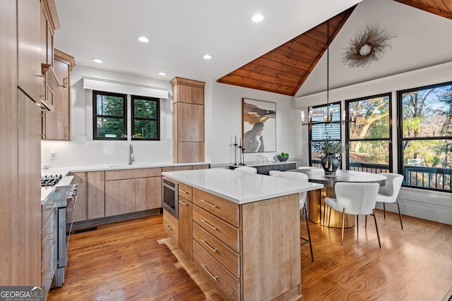 kitchen featuring a kitchen island, a wealth of natural light, and lofted ceiling