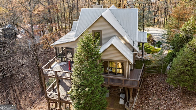 view of home's exterior with a sunroom