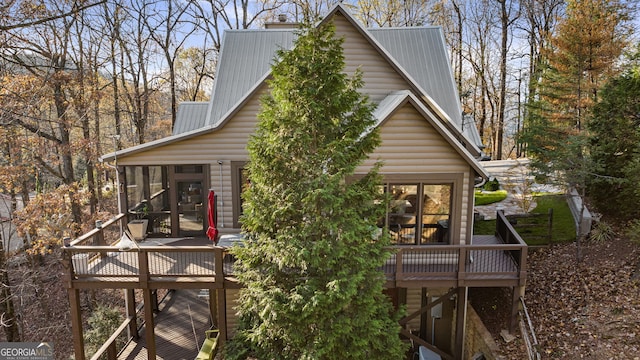 view of side of home featuring a deck and a sunroom