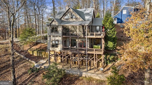 rear view of property with a sunroom