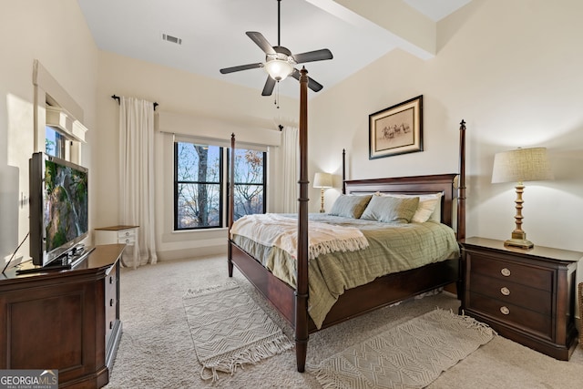 carpeted bedroom with beamed ceiling and ceiling fan