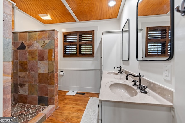 bathroom featuring hardwood / wood-style floors, vanity, wooden ceiling, and walk in shower