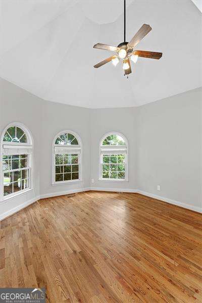 unfurnished living room with crown molding, light hardwood / wood-style floors, french doors, and ceiling fan