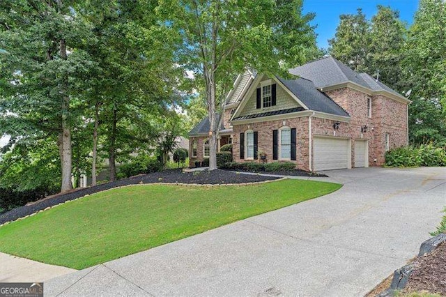 view of front of house with a front yard and a garage