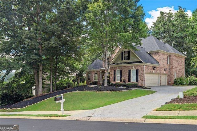 view of front of home featuring a garage and a front yard