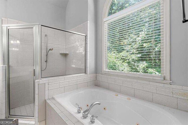 bathroom with tile patterned flooring, vanity, and separate shower and tub