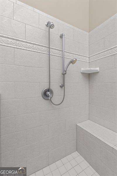 bathroom featuring tile patterned floors, vaulted ceiling, vanity, and plenty of natural light