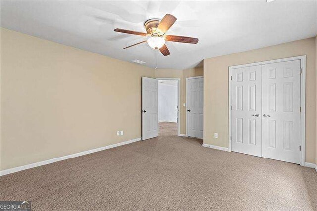 empty room featuring carpet flooring and ceiling fan