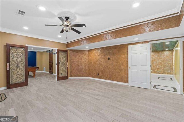 unfurnished living room featuring crown molding, a wealth of natural light, ceiling fan, and light hardwood / wood-style flooring