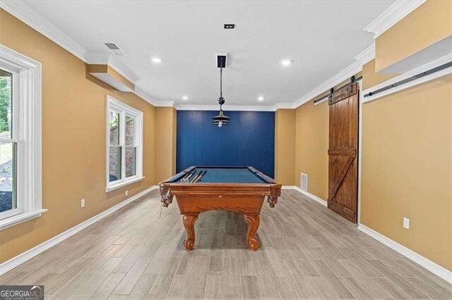 spare room with ornamental molding and light hardwood / wood-style floors