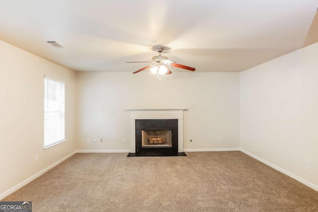 unfurnished living room with light colored carpet and ceiling fan