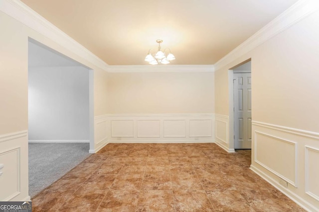 carpeted empty room featuring a chandelier and ornamental molding