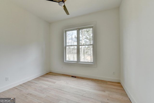 spare room featuring light hardwood / wood-style floors and ceiling fan