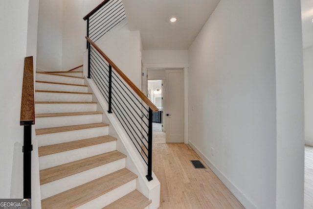 staircase featuring wood-type flooring