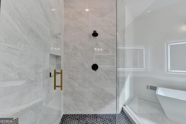 bathroom featuring shower with separate bathtub