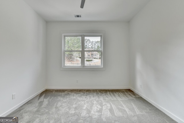 unfurnished room featuring light colored carpet and ceiling fan