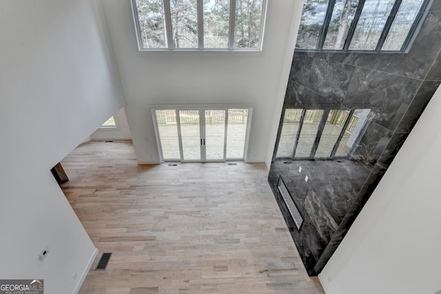 living room featuring a wealth of natural light and light hardwood / wood-style flooring