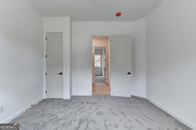 unfurnished bedroom featuring light colored carpet