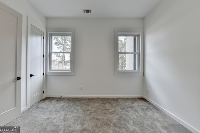 unfurnished room with light carpet