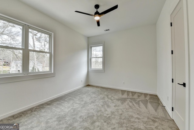 unfurnished bedroom featuring light colored carpet and ceiling fan