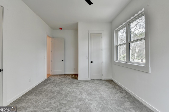 unfurnished bedroom featuring light carpet