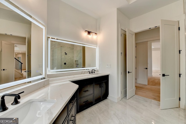 bathroom featuring vanity and an enclosed shower