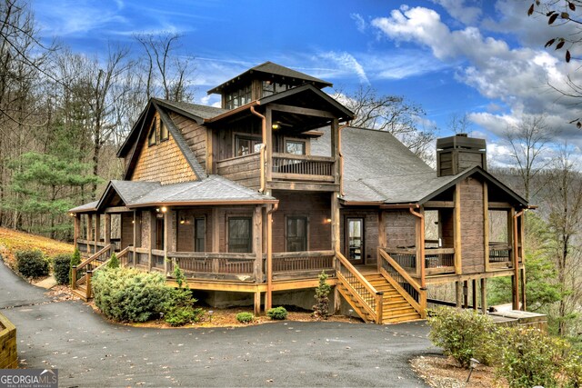 view of front of property with a balcony and a porch