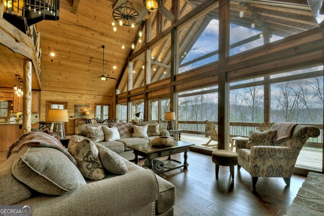 living room with ceiling fan, a healthy amount of sunlight, and high vaulted ceiling