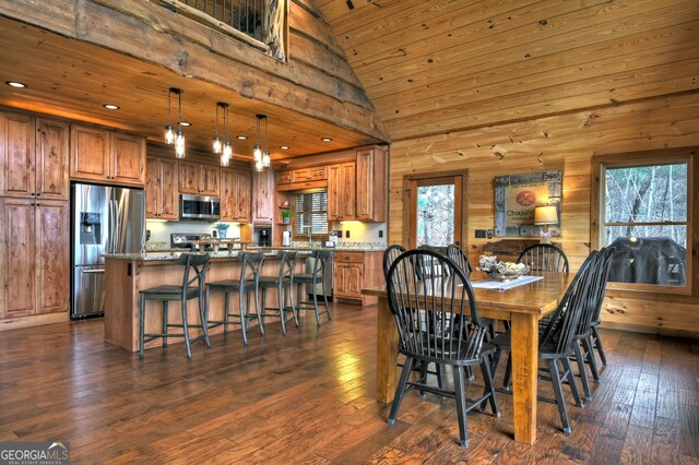 dining space featuring plenty of natural light, dark hardwood / wood-style floors, wood ceiling, and high vaulted ceiling