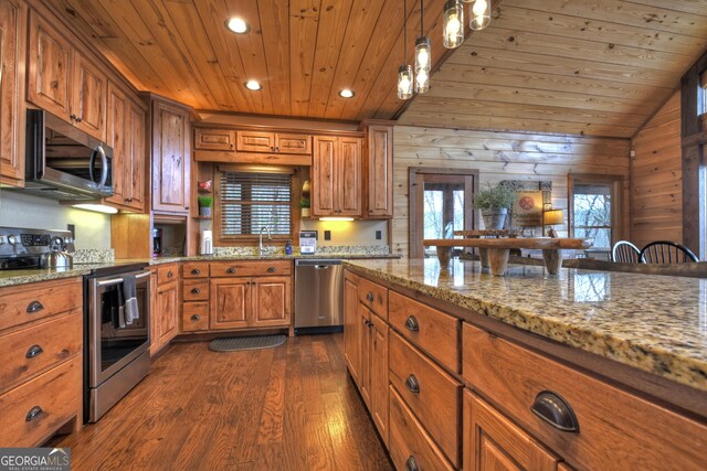 kitchen with wood ceiling, wood walls, light stone countertops, and appliances with stainless steel finishes