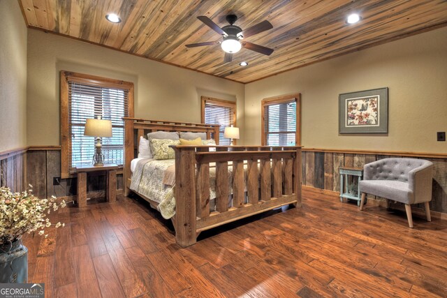 bedroom with ceiling fan, dark wood-type flooring, and wooden ceiling