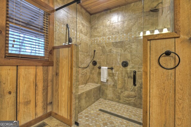 bathroom with wood ceiling, walk in shower, and wooden walls