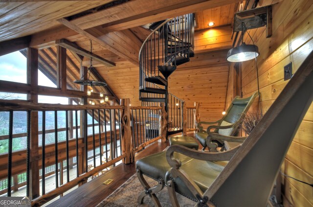 sitting room with hardwood / wood-style floors, wood walls, high vaulted ceiling, beamed ceiling, and wood ceiling