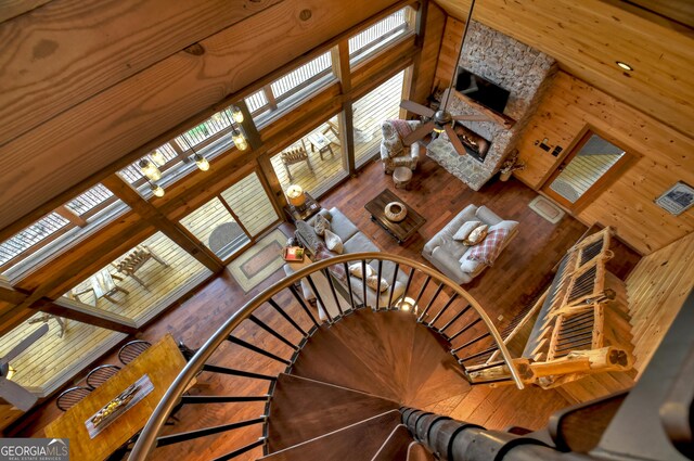 staircase with a high ceiling and wood-type flooring