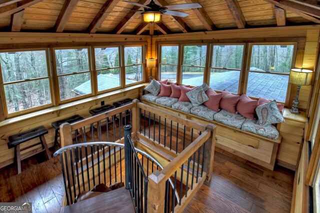 living room with vaulted ceiling with beams, ceiling fan, dark wood-type flooring, and wood ceiling