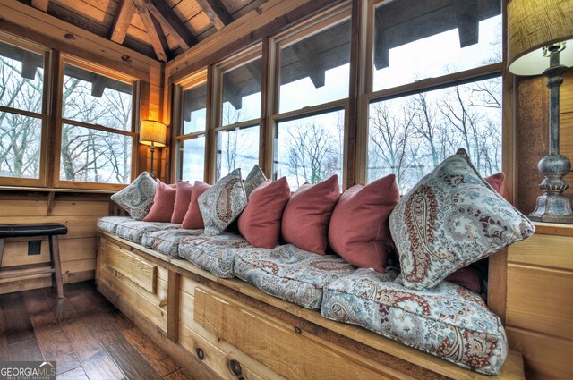 living room featuring wooden ceiling, lofted ceiling with beams, dark wood-type flooring, and a healthy amount of sunlight