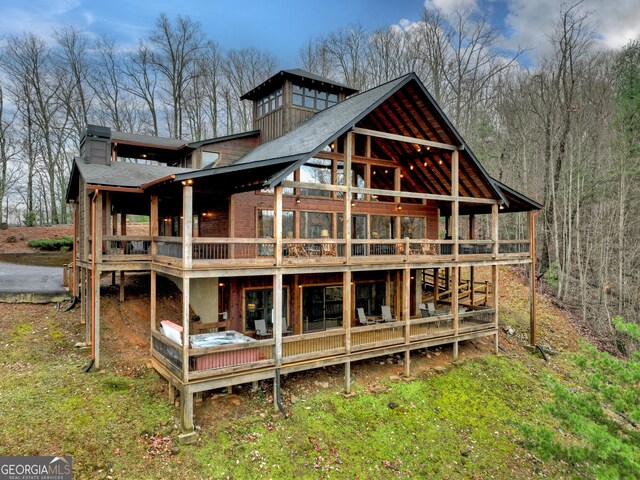 back of house with a wooden deck