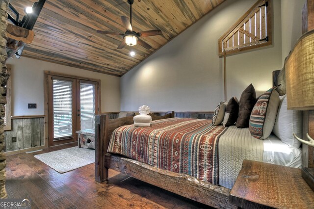 bedroom with ceiling fan, wooden ceiling, dark hardwood / wood-style floors, lofted ceiling, and wooden walls