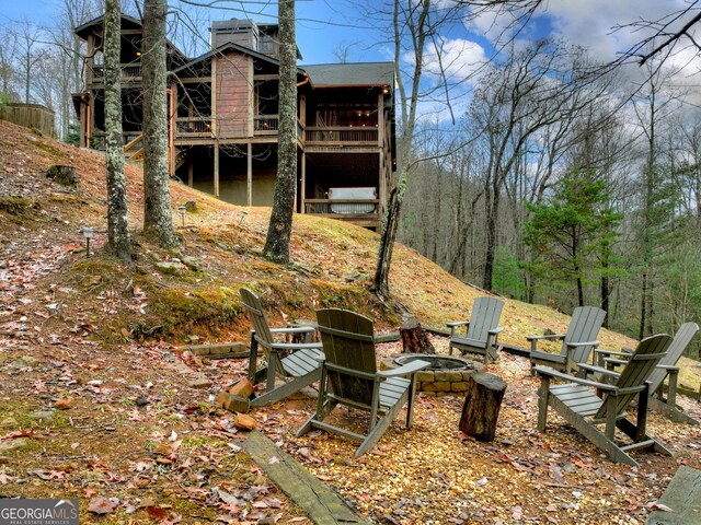 view of yard with a fire pit and a deck