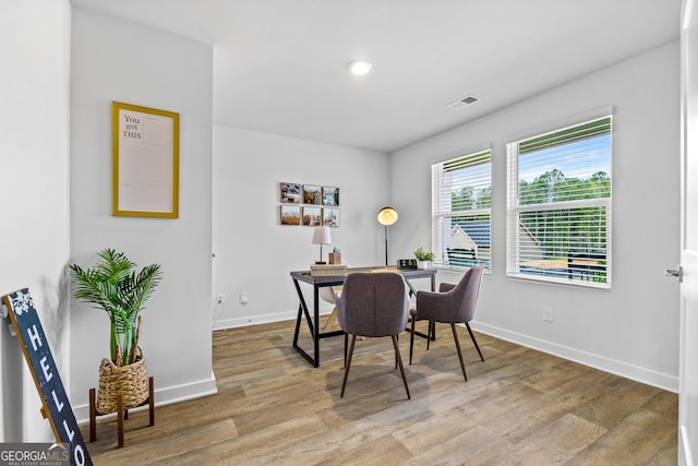 dining space with light hardwood / wood-style floors