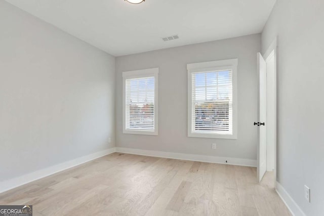 unfurnished room with light hardwood / wood-style flooring