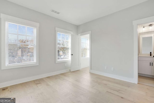 spare room with light hardwood / wood-style flooring