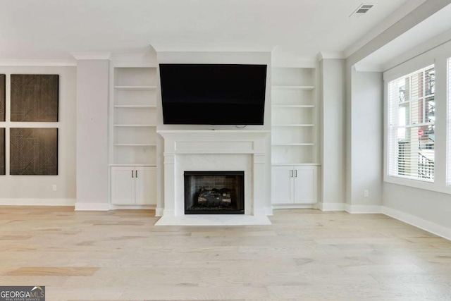 unfurnished living room featuring light hardwood / wood-style flooring and ornamental molding