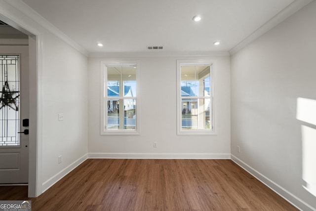 interior space with ornamental molding and wood-type flooring