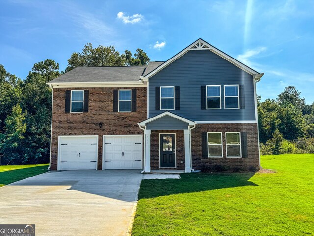 view of front of house with a garage and a front lawn