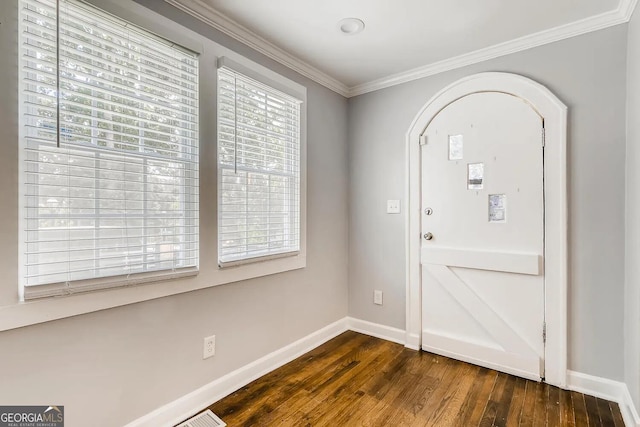 foyer with crown molding and dark hardwood / wood-style flooring