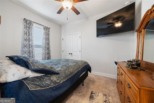 bedroom with light carpet, a closet, and ceiling fan