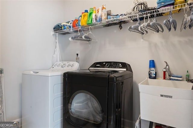 laundry area featuring independent washer and dryer and sink