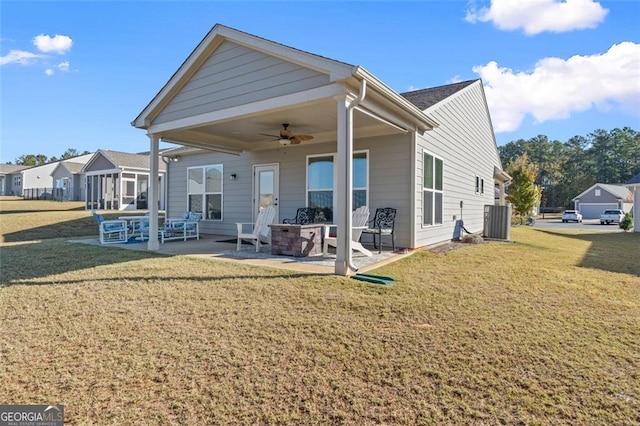 back of property featuring ceiling fan, a patio, cooling unit, and a lawn