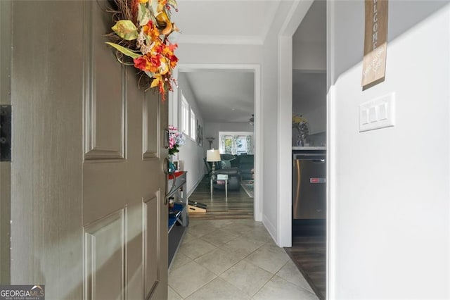 hallway featuring light hardwood / wood-style floors and crown molding